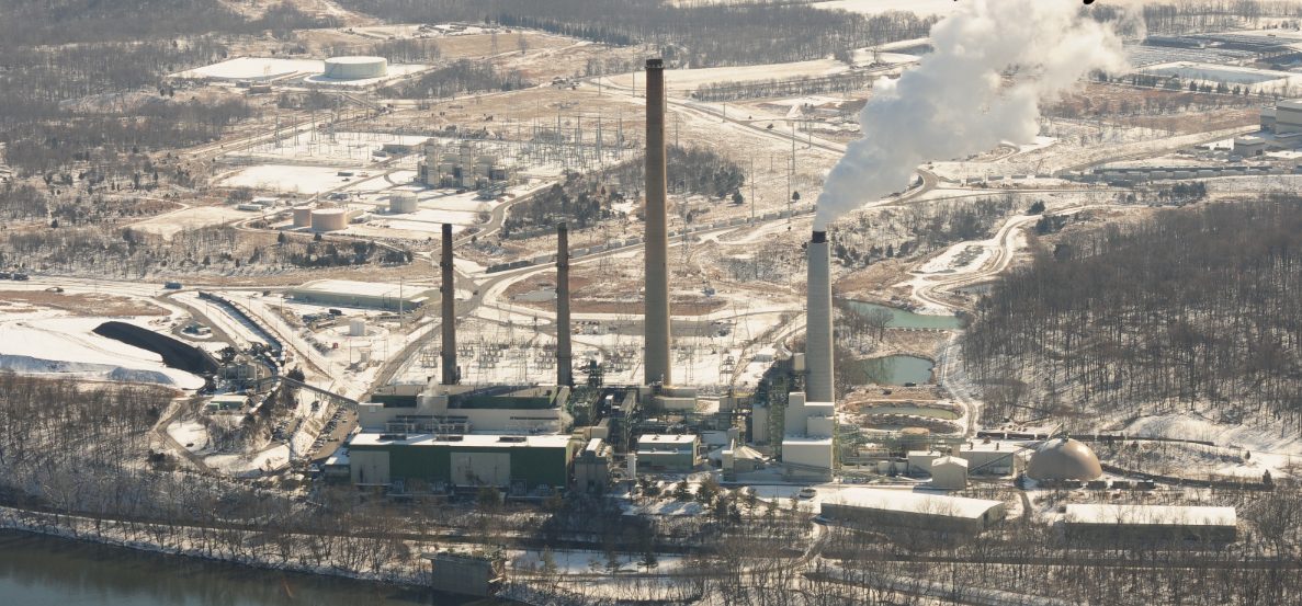 Aerial view of a former power generation plant along a river in winter