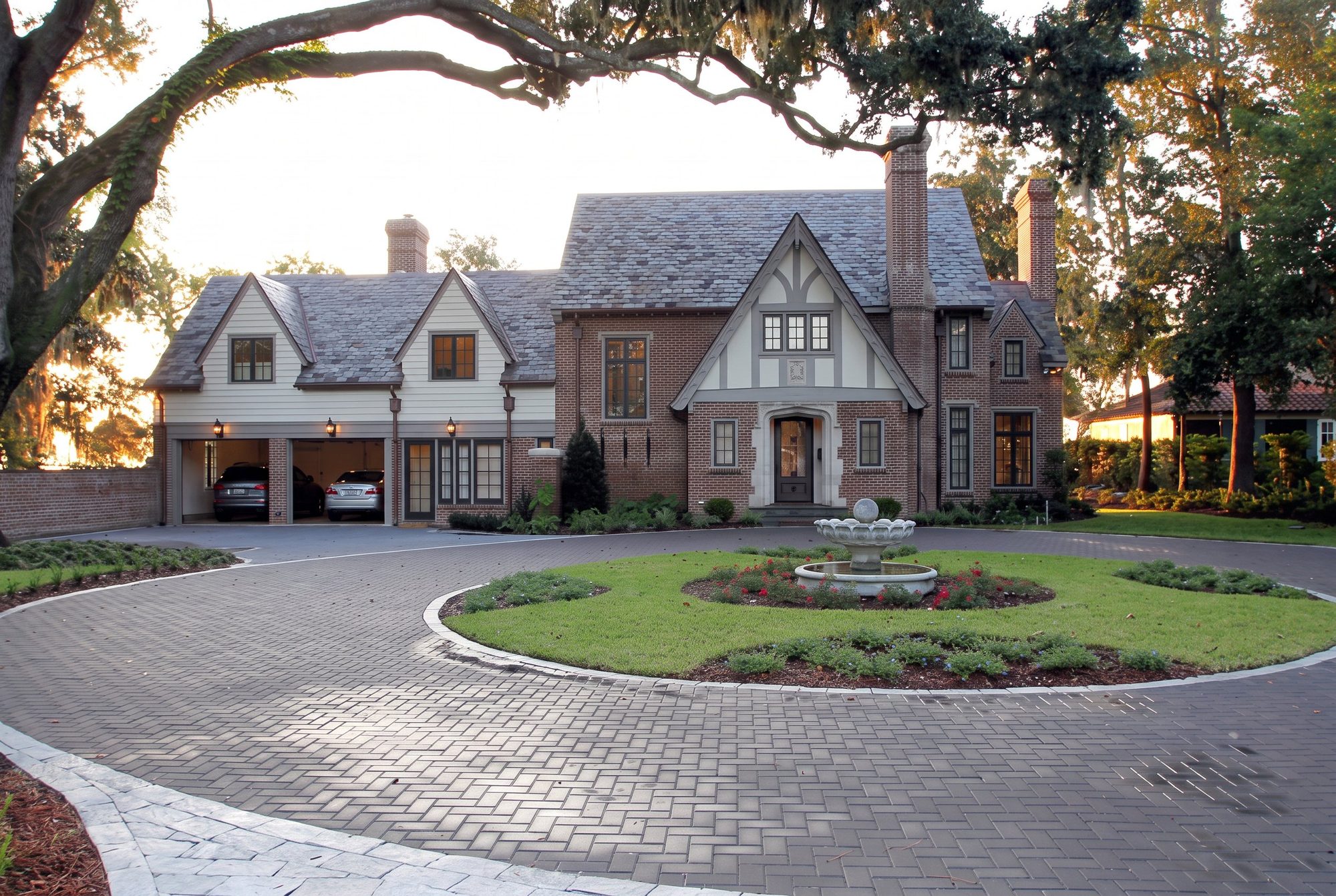 Brick and stucco Tudor style residence with paver circular drive built by McAneny Builders in Jacksonville, Florida