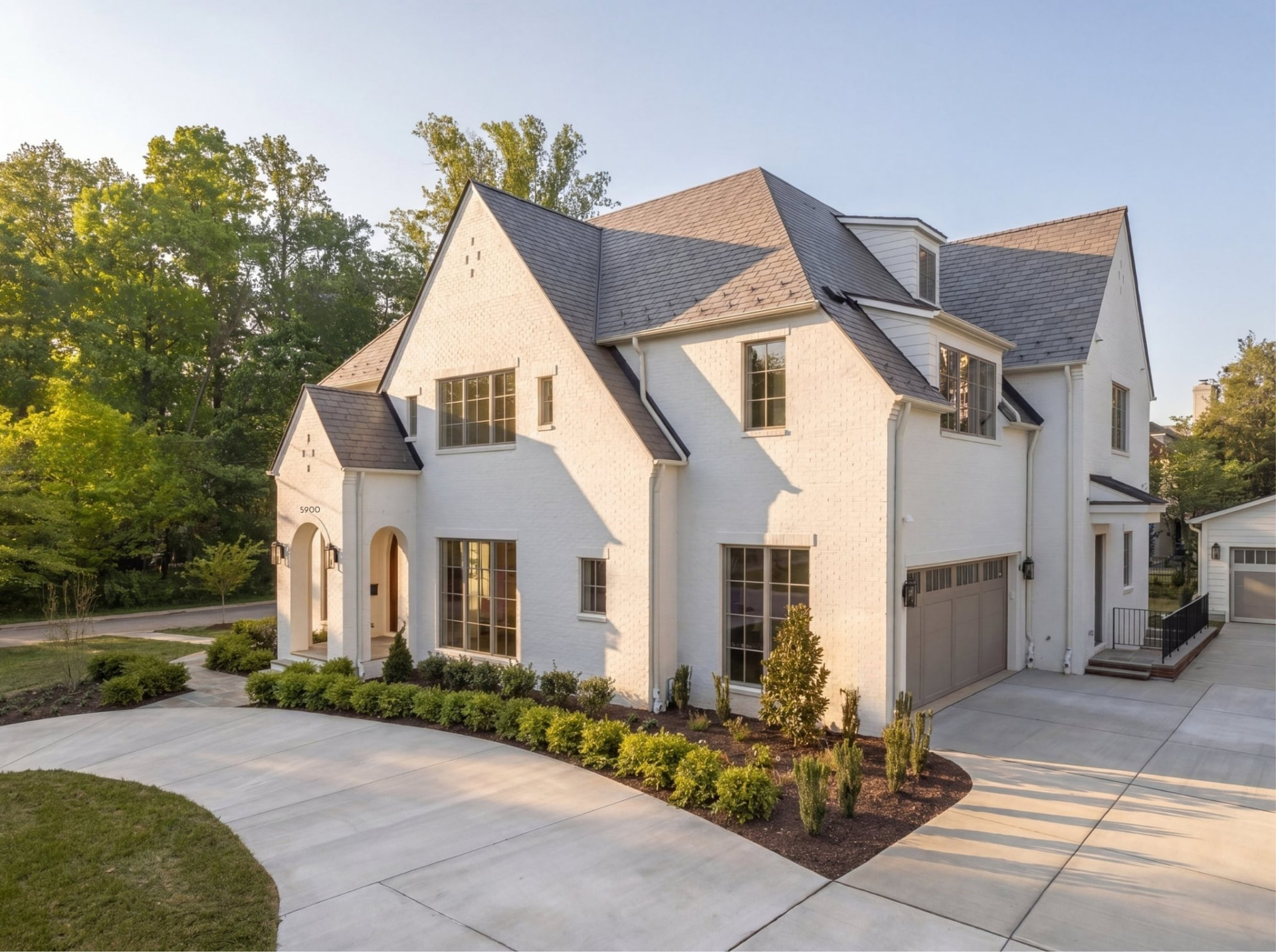 White painted brick custom home with slate roof built by Terra Build